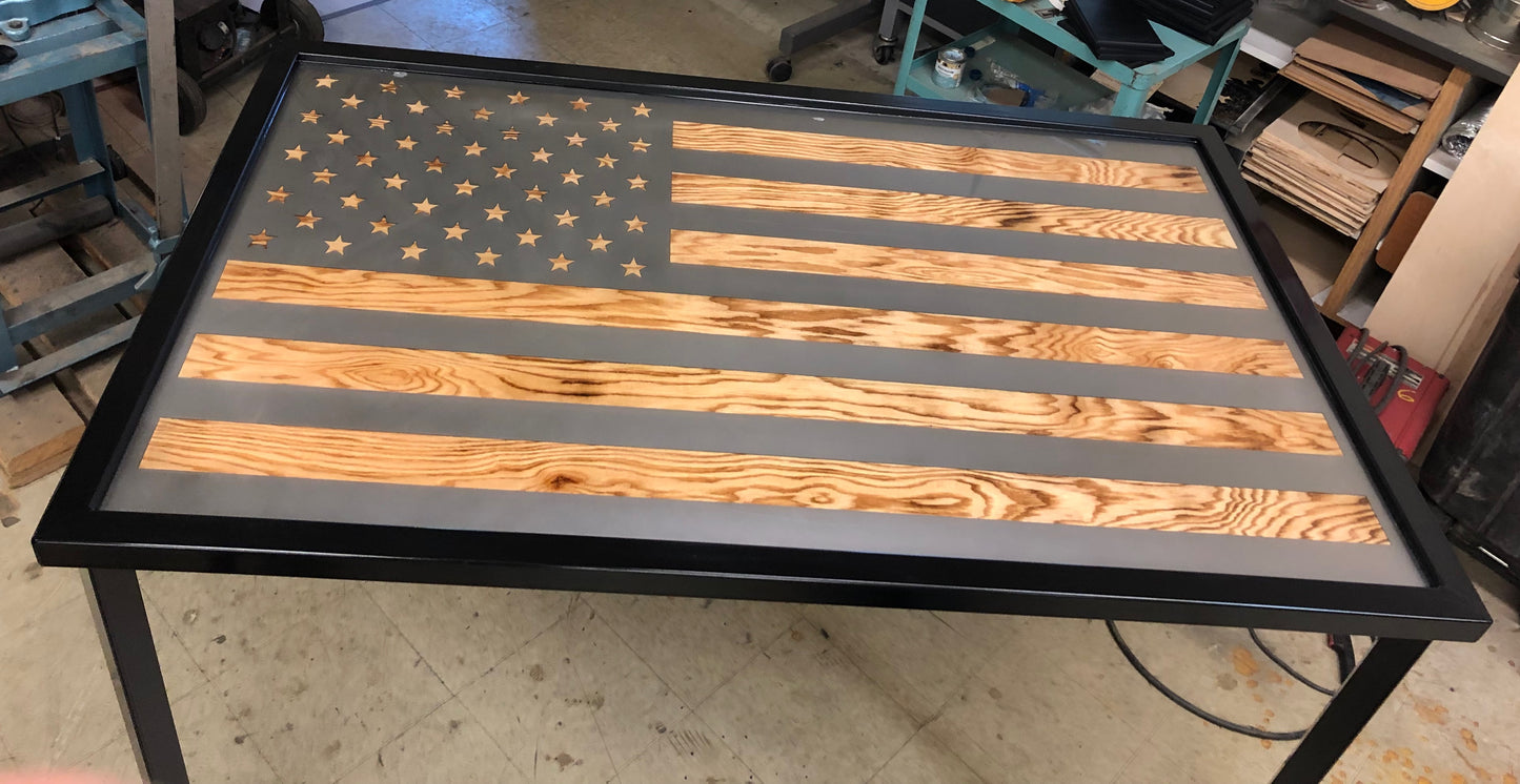 Metal framed american flag table with wood grain popping through the flag stripes and stars